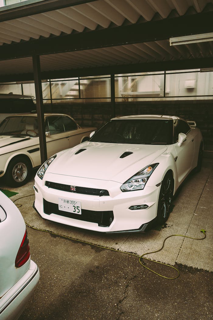 White Nissan GT-R parked in a carport in Kyoto, showcasing sleek design and power.